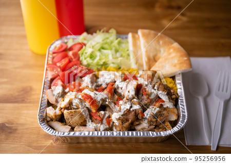 chicken over rice in aluminum bowl, new york style famous halal food chicken over rice in aluminum bowl, new york style famous halal food 95256956