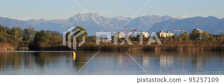 Houses in Wetzikon, shore of Lake Pfaeffikersee and mountain ranges. 95257109