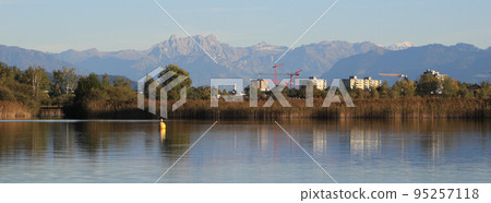 Houses in Wetzikon, shore of Lake Pfaeffikersee and mountain ranges. 95257118