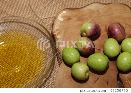 Olives and Olive Oil on wooden background Olives and Olive Oil on wooden background 95259750