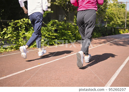 Back view of two middle-aged women jogging Back view of two middle-aged women jogging 95260207