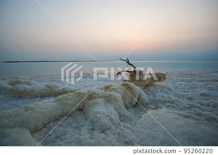 Beautiful sunrise at Dead Sea in Israel with rocks of salt at foreground 95260220