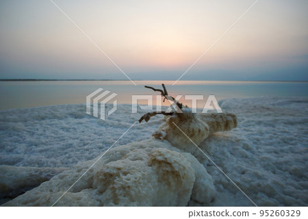 Beautiful sunrise at Dead Sea in Israel with rocks of salt at foreground 95260329