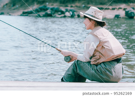 A woman enjoying fishing A woman enjoying fishing 95262169