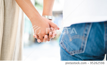 Man and woman holding hands couple gender 95262598