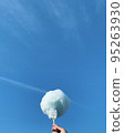 Cotton candy spinning clouds in the blue sky 95263930