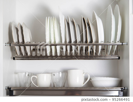 Storage of clean dishes in a separate kitchen section with a lifting mechanism. Modern kitchens 95266491