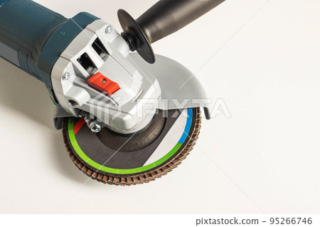 Professional angle grinder with flap wheel for processing wooden surfaces. Construction power tool. Industry, close-up Professional angle grinder with flap wheel for processing wooden surfaces. Construction power tool. Industry, close-up 95266746