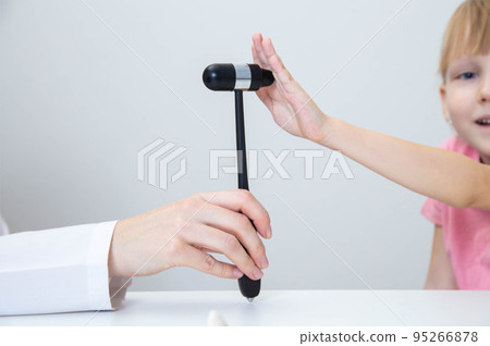 Hand of little girl and neurological hammer of doctor neuropathologist on white background, close-up. Extensor muscle 95266878