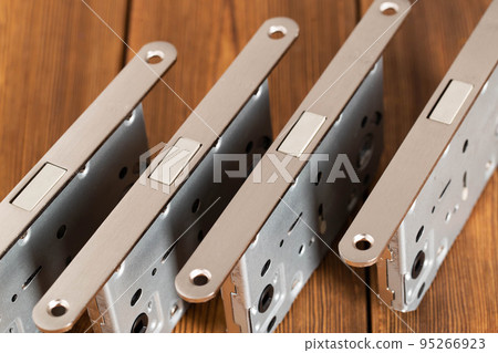 Door latch plumbing magnetic on a wooden background. Door furniture, close-up Door latch plumbing magnetic on a wooden background. Door furniture, close-up 95266923