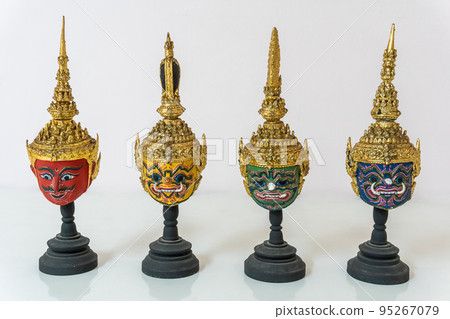 A small red, green, yellow, blue actor's mask is set on a white background. A small red, green, yellow, blue actor's mask is set on a white background. 95267079