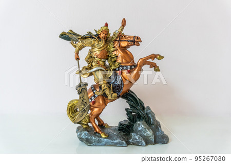 Small statue of Guan Yu on horseback riding horse for home decoration on white background 95267080