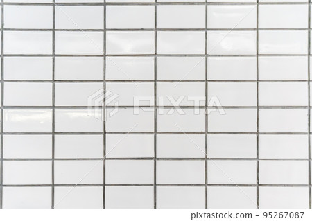 The white tiles on the walls are arranged in an orderly fashion. The white tiles on the walls are arranged in an orderly fashion. 95267087