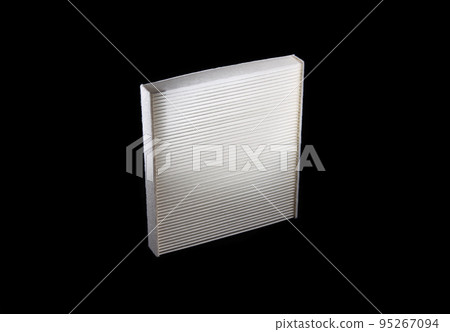 White cabin filter for cleaning the air in the car interior. Automotive spare part on a black background. Close-up 95267094