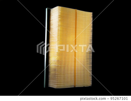 New yellow car air filter on black background. Close-up 95267101