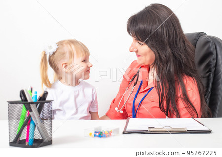 Little caucasian girl 3-4 years old at the appointment with a pediatrician. Varieties of children's doctors, children's medicine Little caucasian girl 3-4 years old at the appointment with a pediatrician. Varieties of children's doctors, children's medicine 95267225
