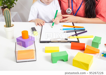 Little caucasian girl 3-4 years old at the appointment with a pediatrician. Varieties of children's doctors, children's medicine 95267226