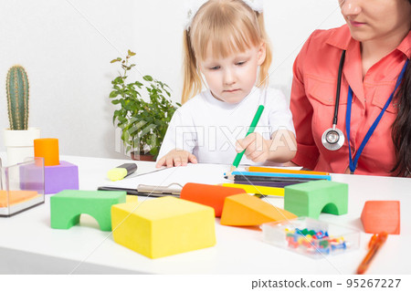 Little caucasian girl 3-4 years old at the appointment with a pediatrician. Varieties of children's doctors, children's medicine 95267227