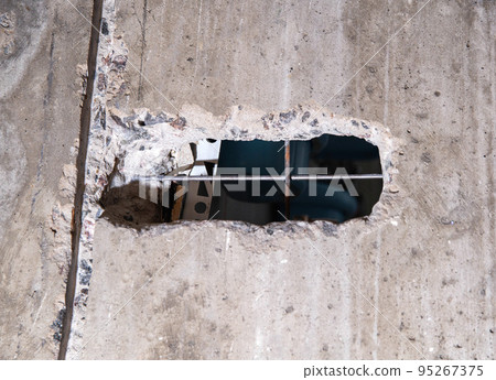 Shtroblenie in concrete walls under the wires and sockets in the wall. Repair in the apartment, preparation for the electrician, close-up Shtroblenie in concrete walls under the wires and sockets in the wall. Repair in the apartment, preparation for the electrician, close-up 95267375