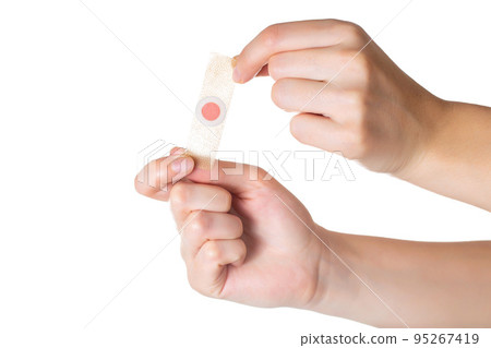 The girl holds in her hands a plaster against core calluses on her legs. White background, isolate, close-up 95267419