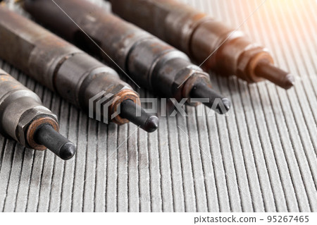 Mechanical injectors from a diesel engine, close-up. Fuel atomization, diesel fuel quality. Close-up, copy space for text Mechanical injectors from a diesel engine, close-up. Fuel atomization, diesel fuel quality. Close-up, copy space for text 95267465