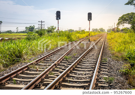 Double track railway in countryside Thailand with traffic lights signaling Double track railway in countryside Thailand with traffic lights signaling 95267600