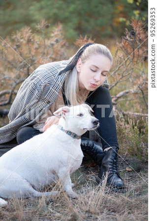Young attractive woman playing with dog 95269353