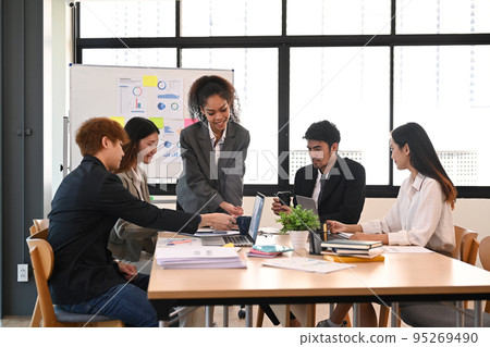 Group of young smart business people brainstorming, working on new start up project in office Group of young smart business people brainstorming, working on new start up project in office 95269490