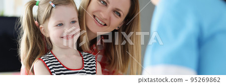 A nurse takes a blood test from a finger of a little girl A nurse takes a blood test from a finger of a little girl 95269862
