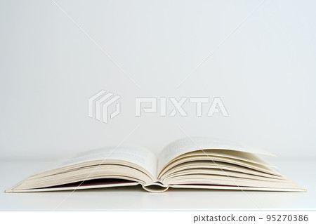 Open book on the table. A book with a white page on a light empty background. Education, school, study, reading concept 95270386