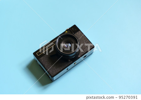 Vintage film camera on a color minimal background. Photography, hipster lifestyle concept Vintage film camera on a color minimal background. Photography, hipster lifestyle concept 95270391