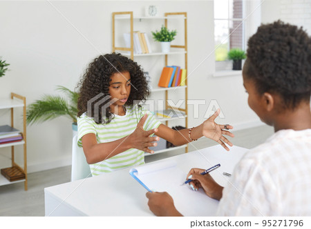 Girl is taking exam to teacher in humanities subject, actively gesticulating. Story, presentation, composition, literature. 95271796