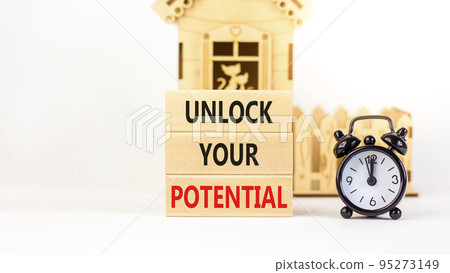 Unlock your potential symbol. Concept words Unlock your potential on wooden blocks. Black alarm clock. Beautiful white background. Business, psychological unlock your potential concept. Copy space. 95273149