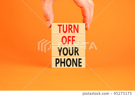 Turn off your phone symbol. Concept words Turn off your phone on wooden blocks. Beautiful orange background. Businessman hand. Business psychological turn off your phone concept. Copy space. Turn off your phone symbol. Concept words Turn off your phone on wooden blocks. Beautiful orange background. Businessman hand. Business psychological turn off your phone concept. Copy space. 95273173