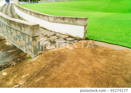 Ramp for wheelchairs in the park, Stone staircase in the garden, Stair ramp with green artificial turf in the park Ramp for wheelchairs in the park, Stone staircase in the garden, Stair ramp with green artificial turf in the park 95274177