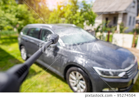 High-tech car wash with car shampoo with gloss and wax for paintwork in nature High-tech car wash with car shampoo with gloss and wax for paintwork in nature 95274504