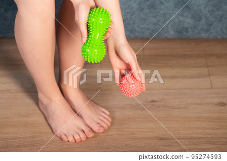 Red and green body foot massager. Medical home physiotherapy. Copy space for text Red and green body foot massager. Medical home physiotherapy. Copy space for text 95274593