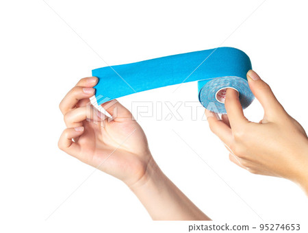 The girl holds in her hands on a white background a kinesiological tape of blue color, isolate. Taping muscles and joints, close-up The girl holds in her hands on a white background a kinesiological tape of blue color, isolate. Taping muscles and joints, close-up 95274653