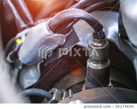 Automotive sensor lambda probe in a diesel engine. Measuring oxygen content in car exhaust gases, macro 95274656