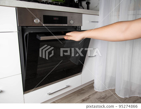 Black modern electric oven in white kitchen with thermo grill and convection function. 3d hot air and vario-grill, large 95274866