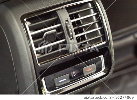 Rear air ducts with deflectors and temperature control for rear passengers in the car. 3 zone climate control, close-up Rear air ducts with deflectors and temperature control for rear passengers in the car. 3 zone climate control, close-up 95274869