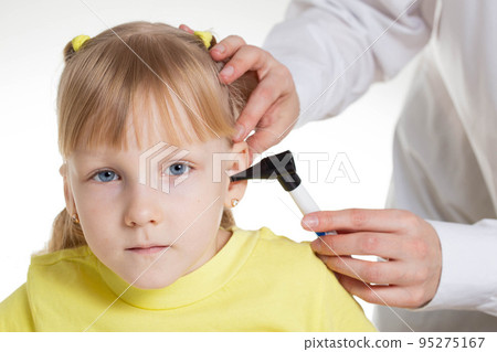 Doctor ENT doctor conducts an otoscopy with a device, close-up. Treatment and routine examination of the ear membranes and ear canals. Girl 5 years old 95275167
