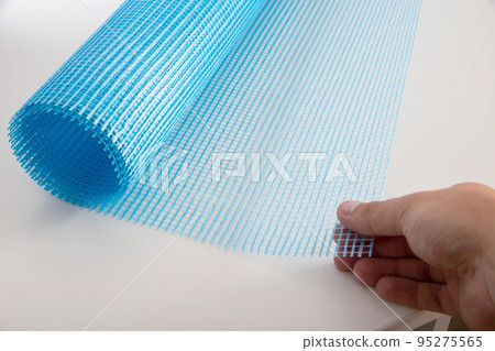 Blue reinforcing construction mesh for wall strengthening on white background, isolate. Close-up Blue reinforcing construction mesh for wall strengthening on white background, isolate. Close-up 95275565