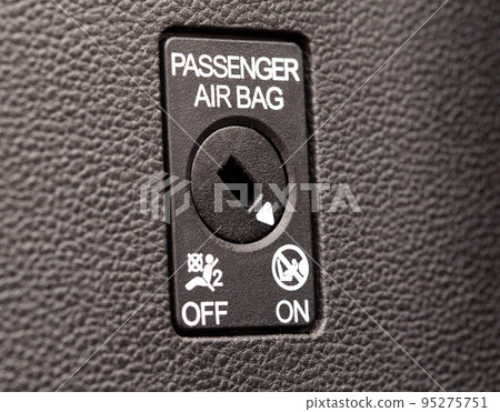 The switch on the panel of the car turns on and off the passenger airbag, macro 95275751