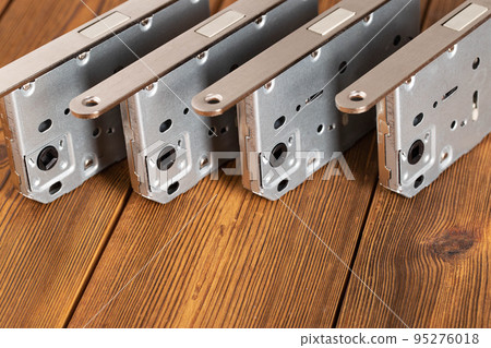 Door latch plumbing magnetic on a wooden background. Door furniture, close-up Door latch plumbing magnetic on a wooden background. Door furniture, close-up 95276018