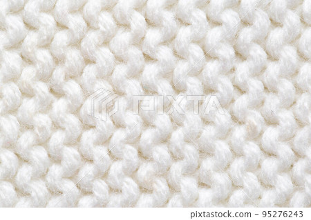 Comfortable warm knitted sweater made of white threads, background. Macro, handmade Comfortable warm knitted sweater made of white threads, background. Macro, handmade 95276243