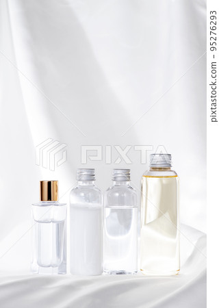Alignment of white satin fabric and 4 cosmetic bottles Alignment of white satin fabric and 4 cosmetic bottles 95276293