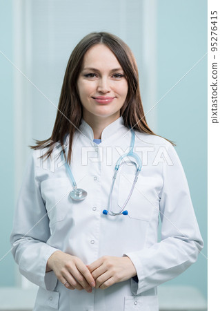 Portrait of young female doctor smiling in private clinic 95276415