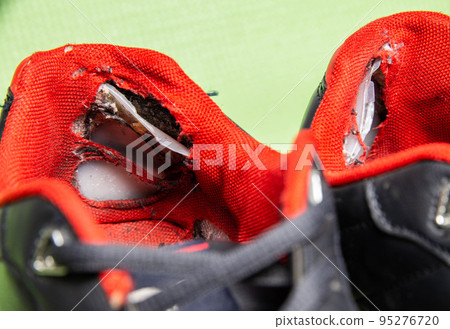 Old worn out ripped sneakers. Torn back in shoes, close-up. Shoe repair Old worn out ripped sneakers. Torn back in shoes, close-up. Shoe repair 95276720