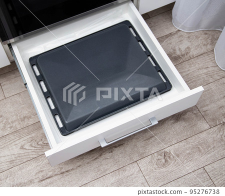 Special drawer in the kitchen for baking sheets and frying pans. modern kitchen 95276738
